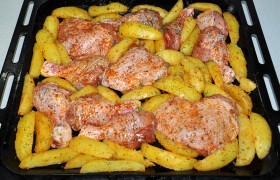 В форме или на противне раскладываем куски курицы, остальное место заполняем картофельными дольками. Последней ложкой маринада еще раз смазываем кистью курицу.