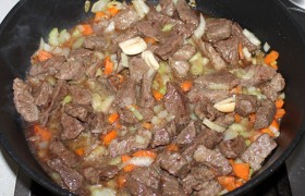 Добавляем мясо и заливаем соус (и сок, слитый из сковородки). Солим и добавляем травы, это могут быть, например,  Итальянские  или  Прованские , перчим.