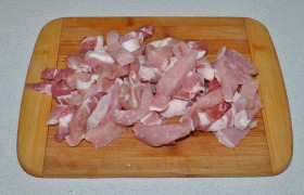 Промытое и максимально обсушенное бумажными полотенцами мясо нарезаем дольками не толще 13-15 мм – лучше поперек мясных волокон.