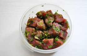 Довольно крупными, примерно по 5 см, кусками-кубиками нарезаем промытое и обсушенное мясо. Рубим зелень, смешиваем с жидким медом, соком лимона, солью и перцем. И все это хорошенько перемешиваем с кусками мяса. Минимум на 2 часа оставляем для маринования в холодильнике.