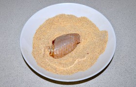 Соединяем муку с куркумой и паприкой, каждый кусочек крылышек обваливаем в этой смеси.