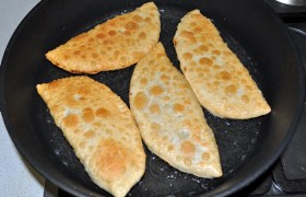 И выкладываем чебуреки на бумажные сложенные полотенца, которые впитают лишнее масло. Ждем, пока немного остынут, отрезаем - как вкусно это соединение тонкого поджаристого теста и сочной мясной начинки!