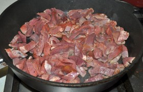 Для правильной жарки и отсутствия масляных брызг – сначала  масло перекаливаем , поставив сковороду на самый сильный огонь, затем закладываем нарезанную мякоть, в раскаленном масле обжариваем примерно 4-5 минут, до посветления долек. Чтобы мякоть не варилась в своем соке – жарим одну часть, за ней – вторую. Вместе с выделившимся соком перекладываем в посуду для тушения, добавляем немного бульона (кипятка), ставим на огонь. 