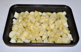 Промазываем маслом форму для запекания. Картошку раскладываем в форме, посыпаем сушеной зеленью. 