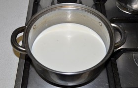 Вливаем оставшееся молоко (330 мл), включаем конфорку и доводим смесь до кипения.